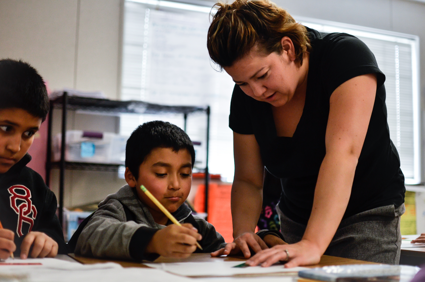 Ms. Cordero works with a third grader to measure perfect walls.
