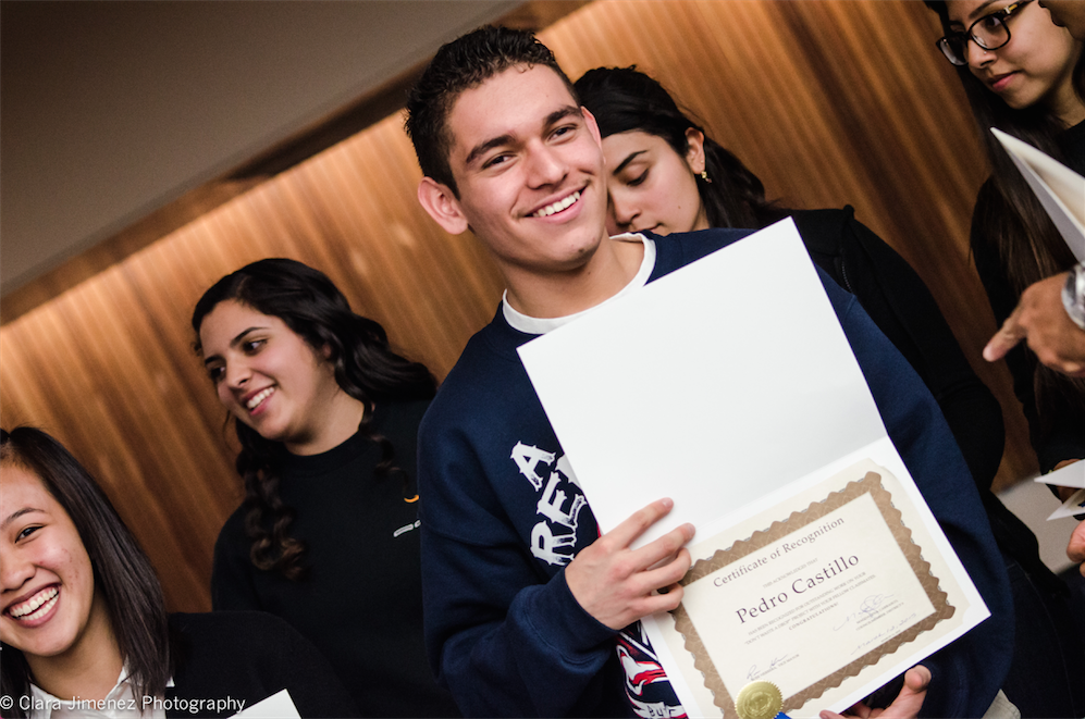 Pedro smiles with his award from the City Council & Board of Supervisors.