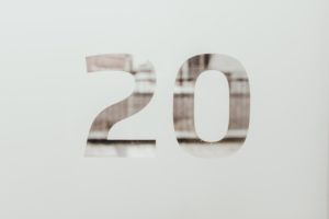 The number 20 masked on glass